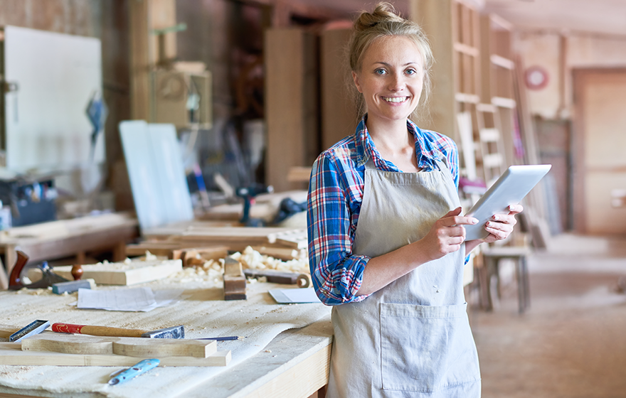 Woman using a tablet in her business workshop