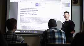 Criminal justice instructor lecturing on policing strategies
