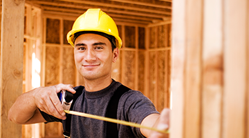 Carpentry student smiling on job site