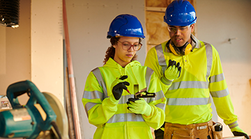 Student working with Instructor on the construction site