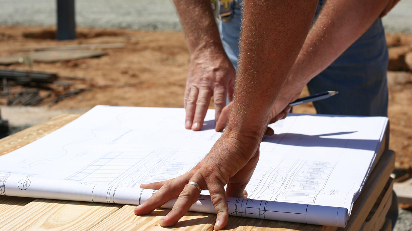 Workers looking at a blueprint