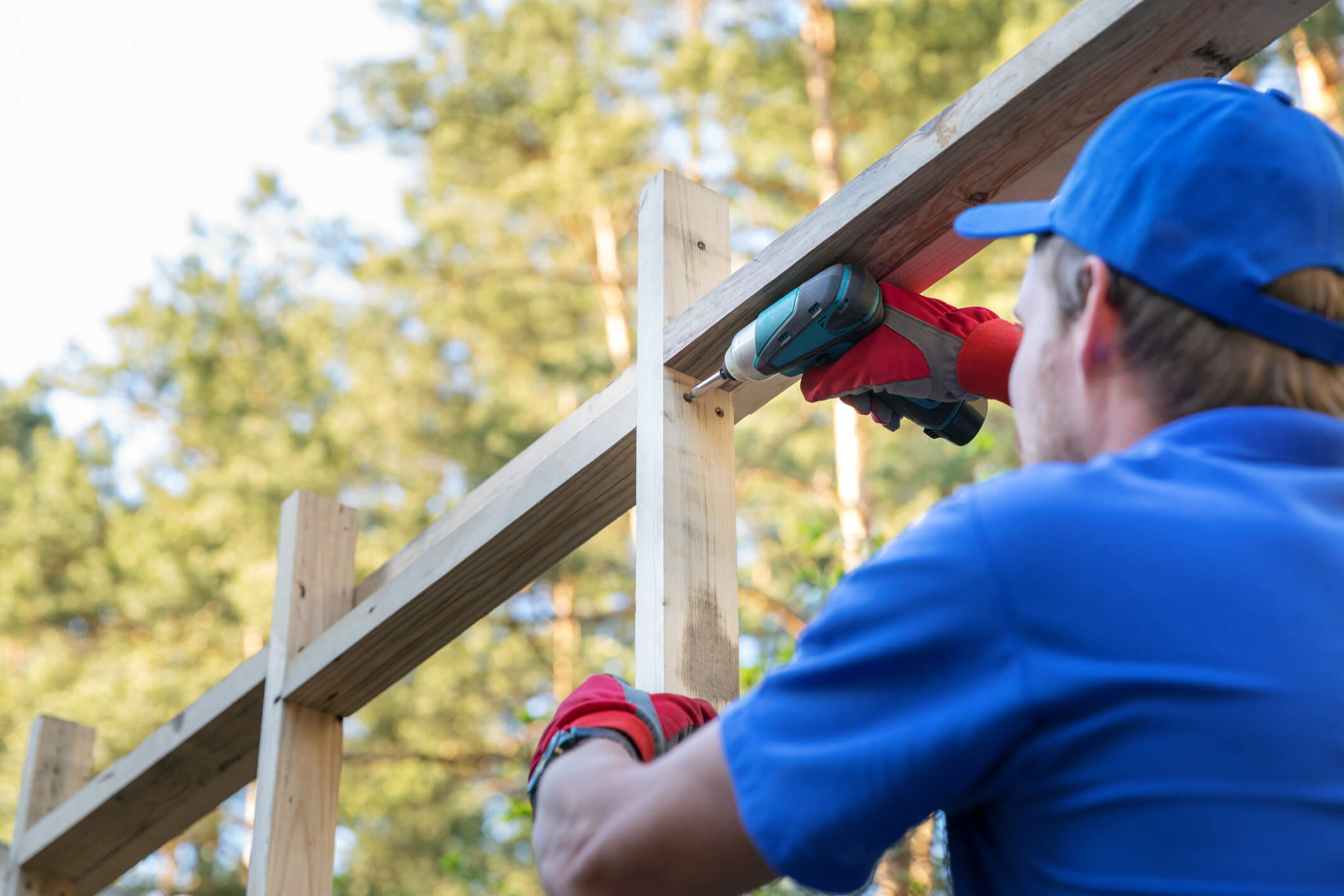 A construction worker working on the framing of a house