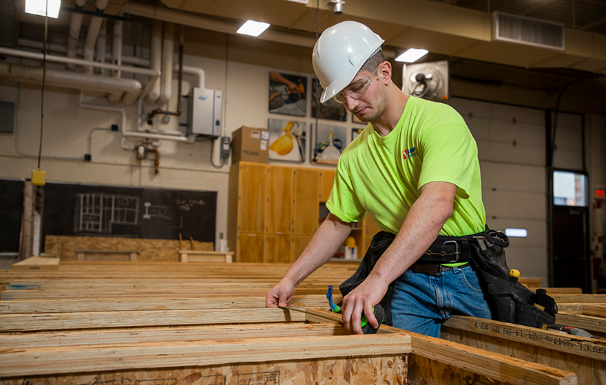A construction student doing hands-on work