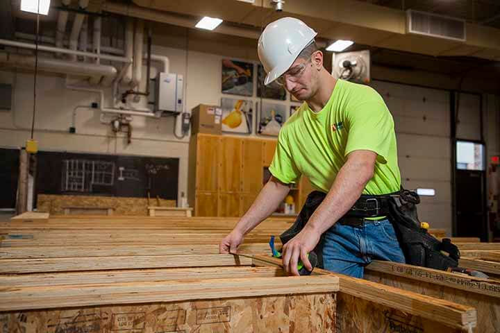 A construction student doing hands-on work