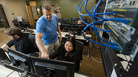 An instructor helping a student at a computer