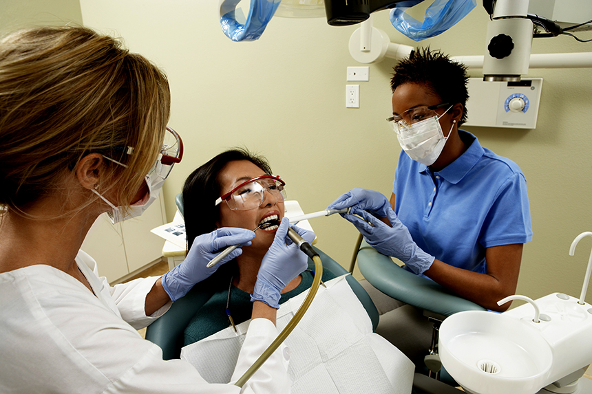 Dentist and Dental Assistant working on patient