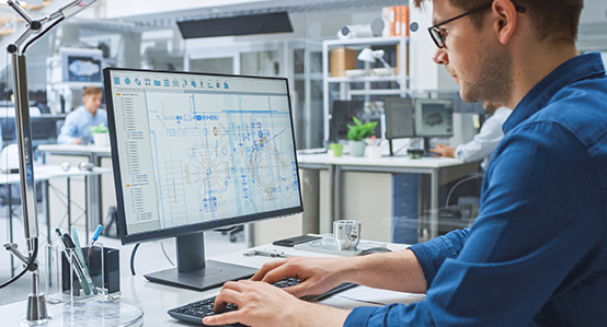 A CAD Technician working with CAD software in an office