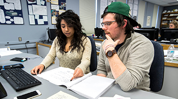 Two students looking at notes