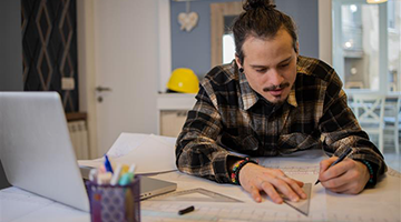 Student working and learning from the comfort of his own home