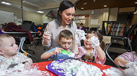 Student and kids playing with shaving cream