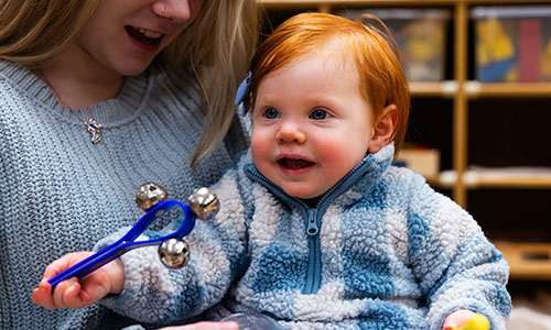 Toddler playing with musical instruments