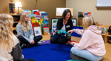 Early Childhood Education staff going through activity plans with students