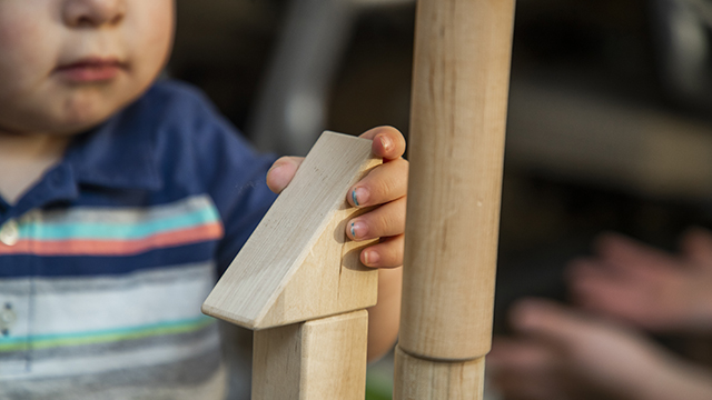 A toddler playing with blocks
