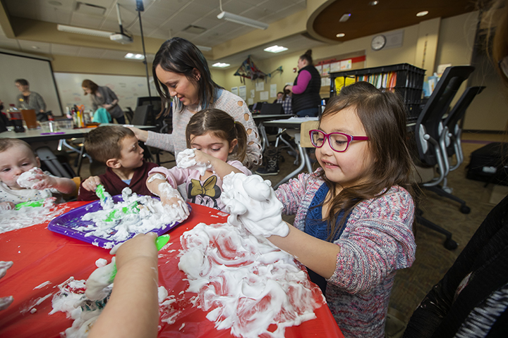 Kids playing with shaving cream in the classroom