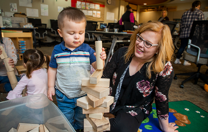 Early Childhood Education student and a child playing with blocks