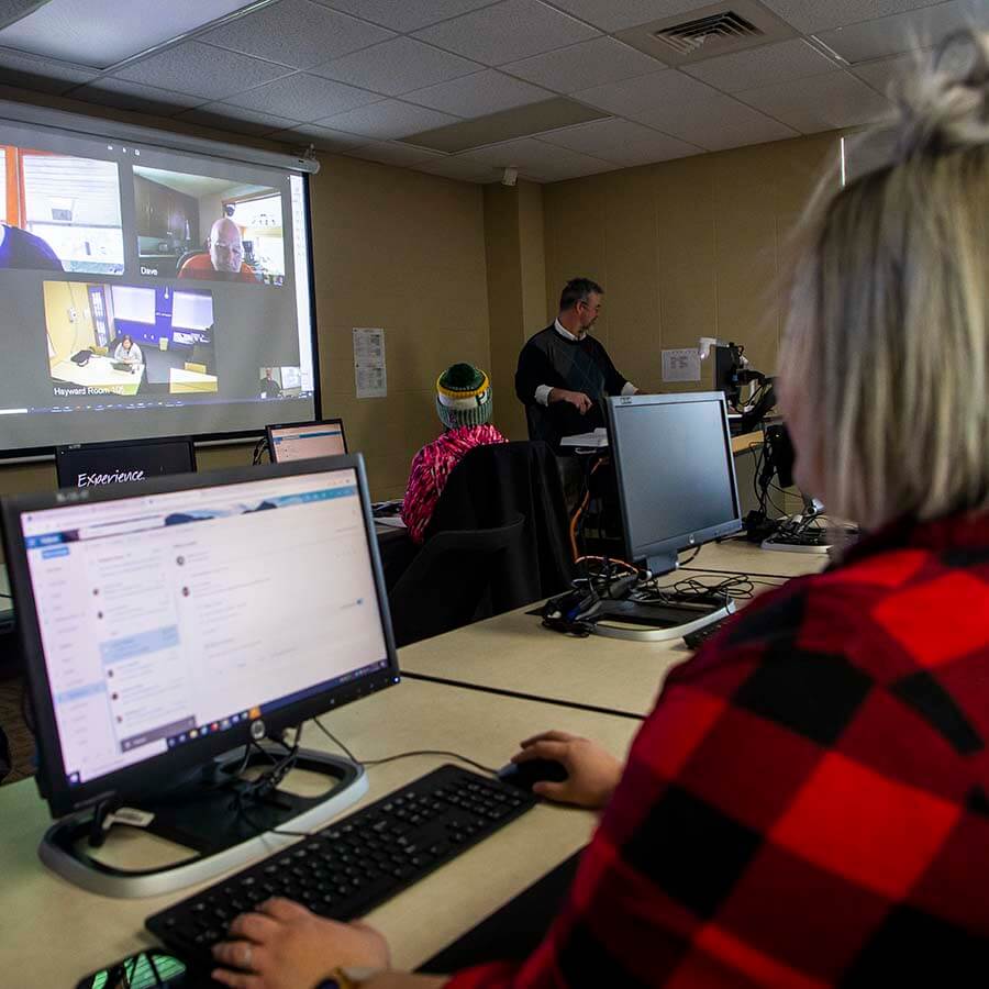 A classroom where there are students attending virtually and in class