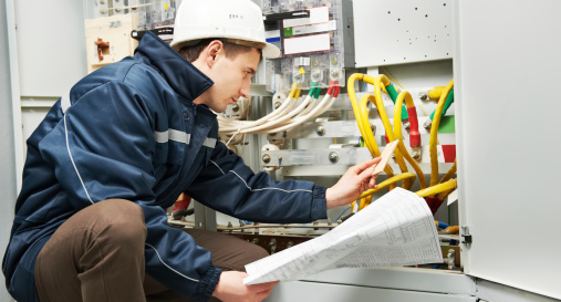 An electrician checking cabling power line