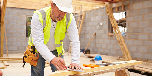  A carpenter working on building a house