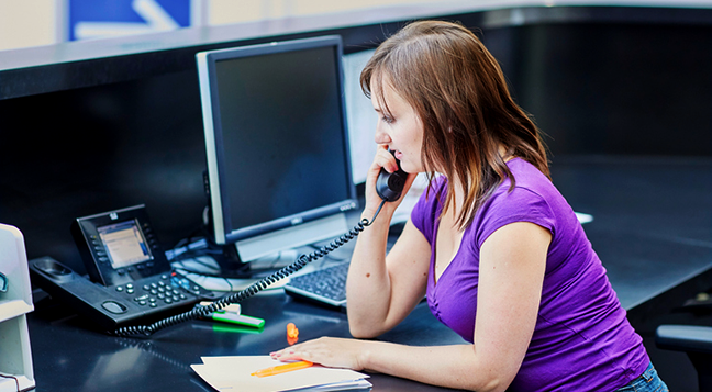 A customer service representative talking on the phone