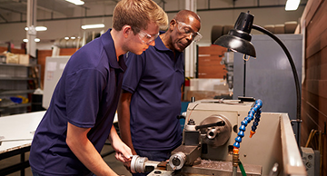 Employee being trained on a milling machine