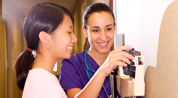 A medical assistant weighing a patient