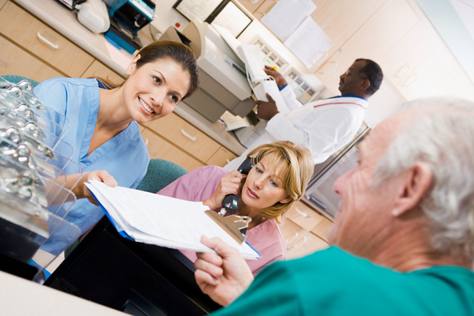 A medical professional handing documents over to a patient