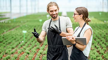 Two farmers in a greenhouse