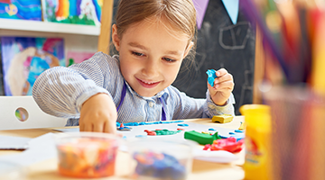 A preschool-aged kid doing an art project