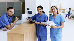 A medical administrative co-workers standing at the front desk