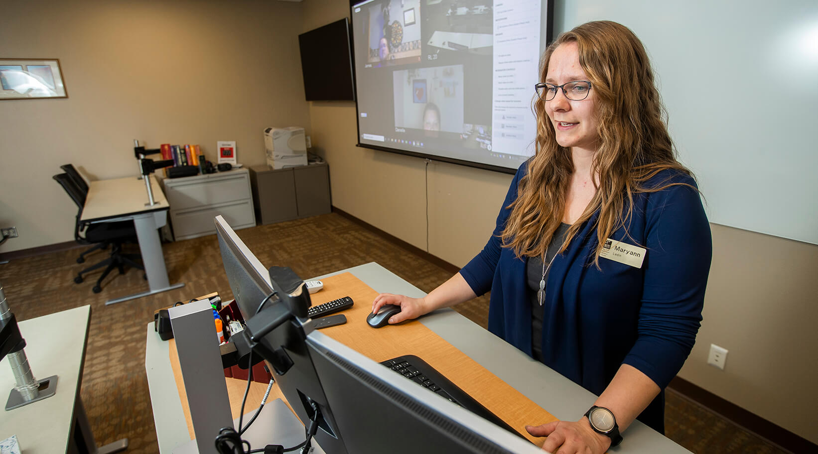 An instructor conducting a classroom where students are virtual and in the classroom