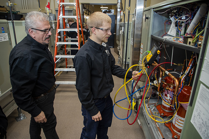 Students doing hands-on work in the HVAC industry