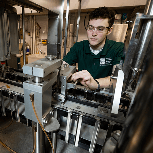 A student doing hands-on work in the automated packaging systems technician program