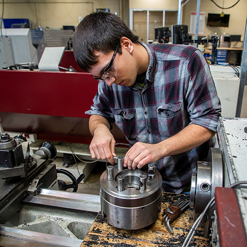 A student doing hands-on work in the automated packaging systems technician program