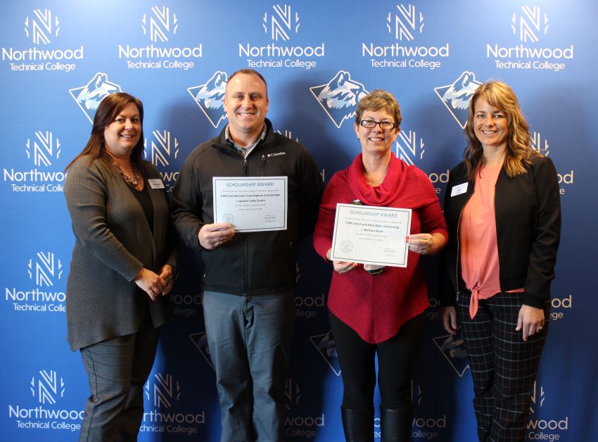 Scholarship recipients standing in front of Northwood Tech backdrop