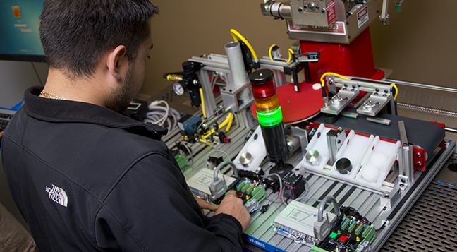 A student looking at the technology used in mechatronics