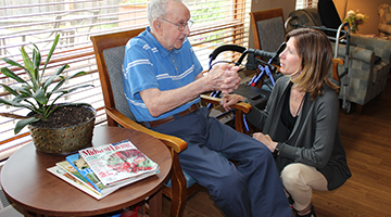 A professional talking with a resident in a community-based residential facility