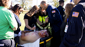 Group of Paramedic students practicing a real-world simulation