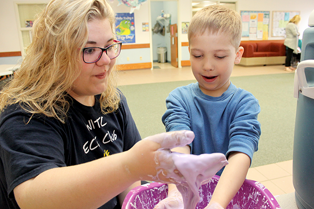 An early childhood education student playing with a young child