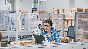 A female doing machine maintenance