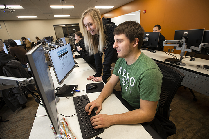 2 IT students working at a computer together