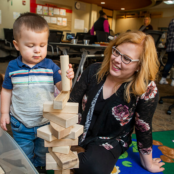 A early childhood education student working with a toddler