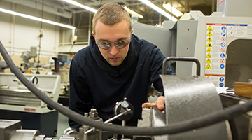 A student working with machinery