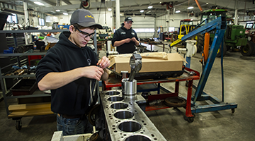 Students working at their own stations in a shop environment