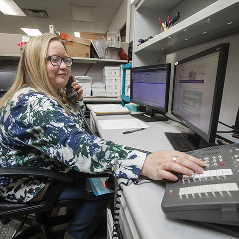 An office professional working on a switchboard