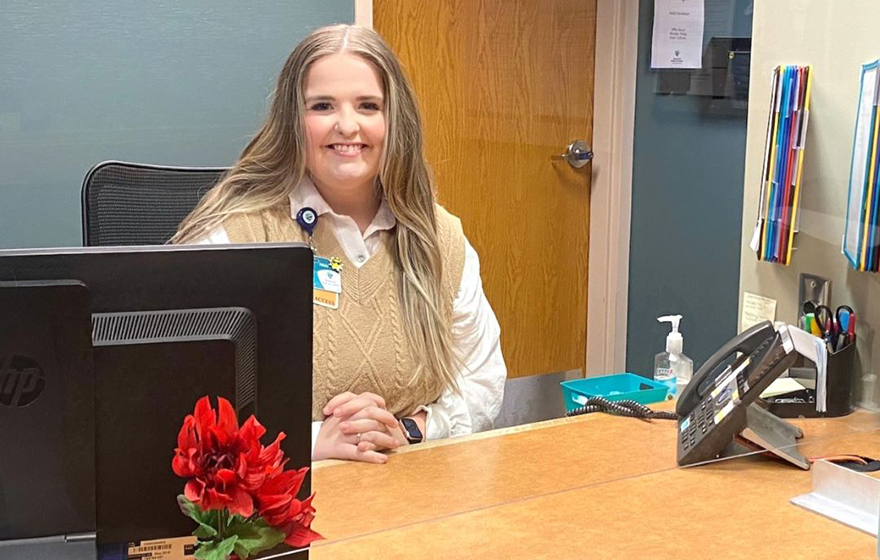 A Medical Administrative Professional sitting at a desk