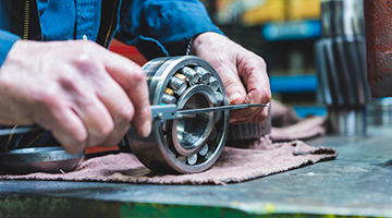 Hands working on bearings