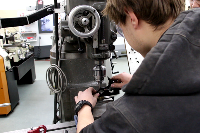 A student working with machinery