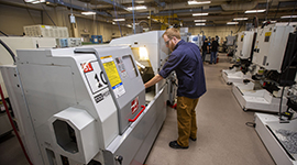 A student working with machinery in the state-of-the-art facilities