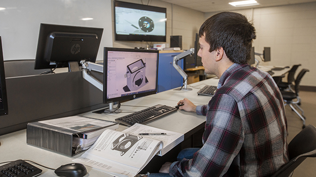 A student creating a blueprint on a computer
