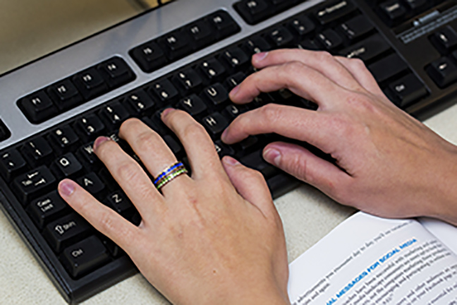 Hands typing on a keyboard